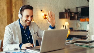 Man have business meeting via video call in a cafe